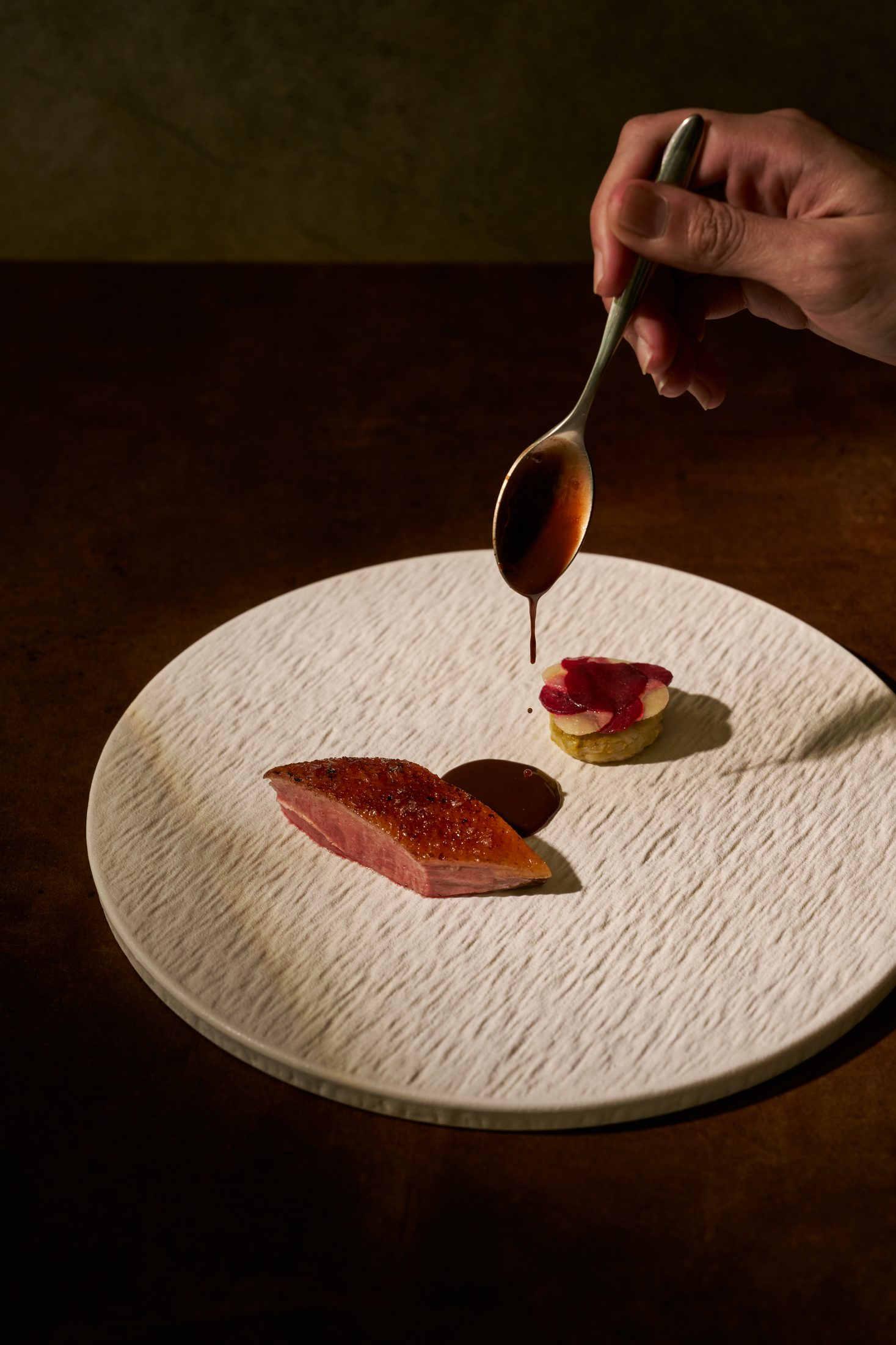 Sangiovese duck — dry-aged barbary duck breast, cherry jus spooned at the pass