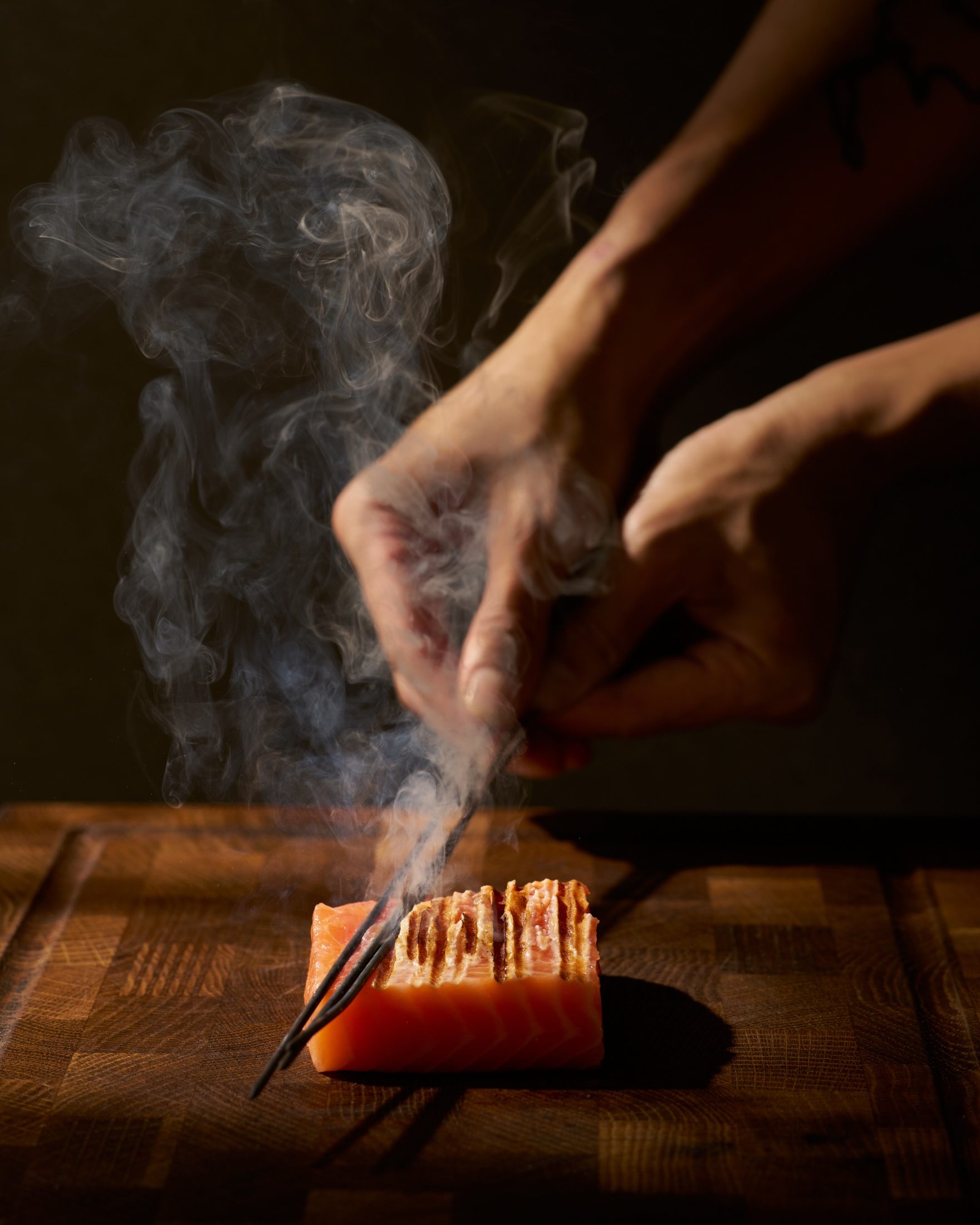 Salmon smoked over embers at the pass
